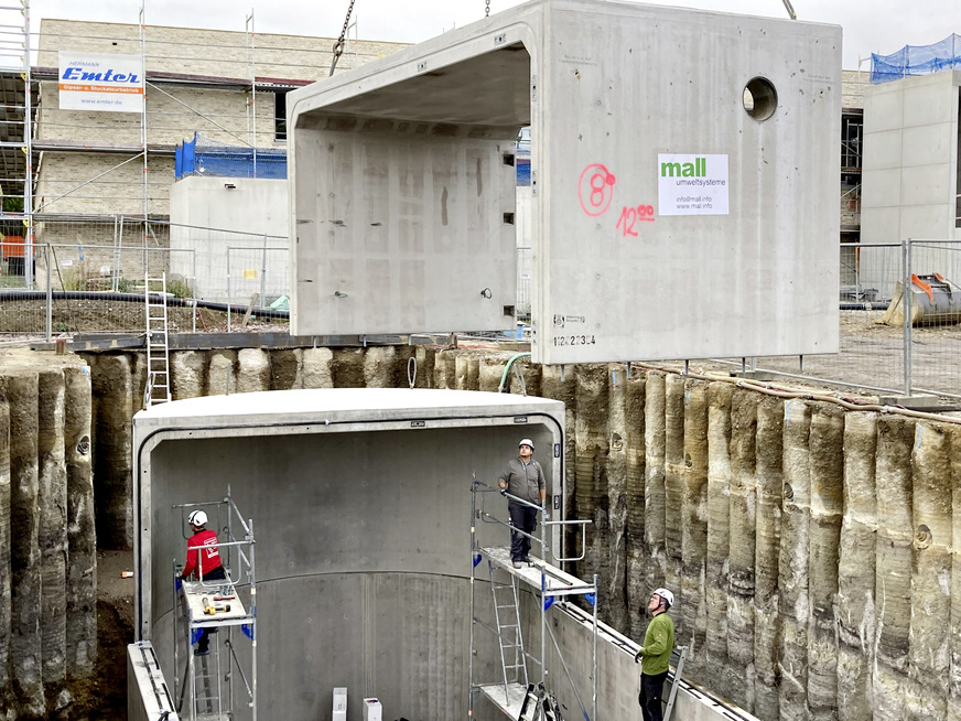 Thermischer Pufferspeicher. Montage der oberen Behälterhälfte in „gestülpter“ Elementbauweise. Jedes U-förmige Segment verlängert den Behälter um drei Meter. An der Seitenfläche die Öffnung für eine DN 350 Rohrdurchführung.