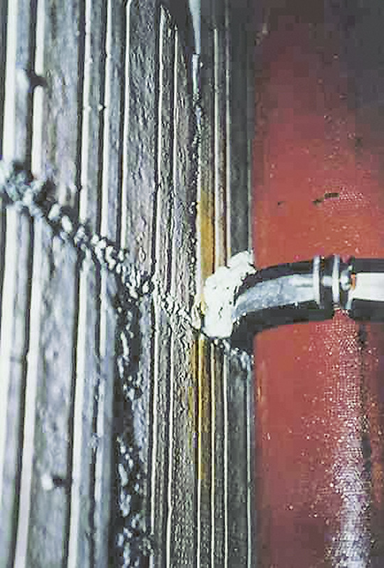Ein Klecks Mörtel verbindet das Gußrohr schalltechnisch mit der Wand